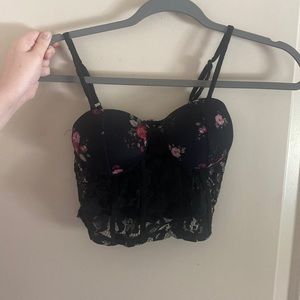 Black Corset brassiere with floral prints. Cupped bra and in size Small.